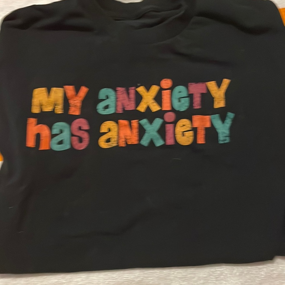 A medium size T-shirt that says “my anxiety has anxiety”
